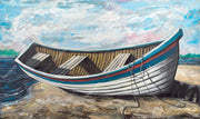 A boat rests on top the sandy mounts along the shore.