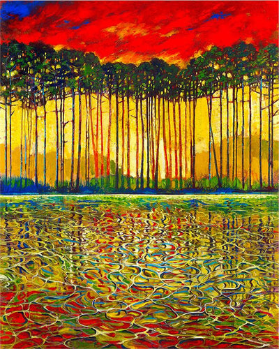 Grove of trees light up through the red sky on an autumn day