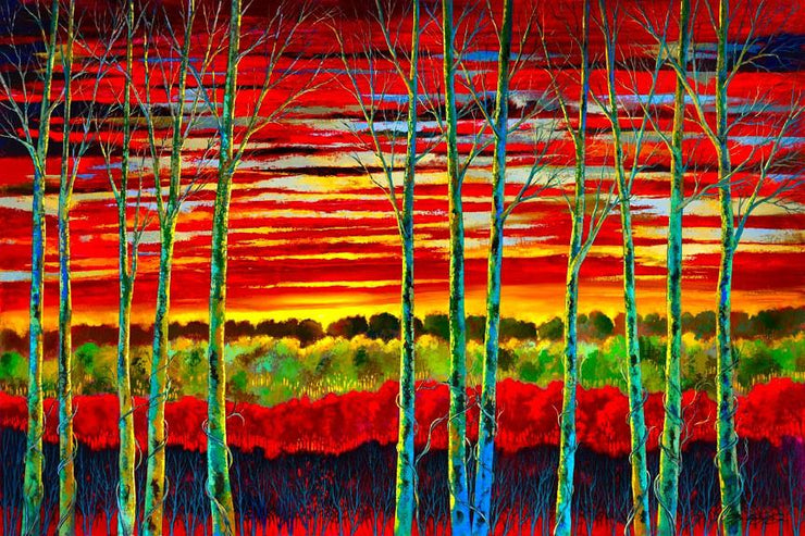 Bare trees line the autumn sunset