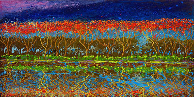 Mirror image on the waterfront of groves of trees in red and blue sky