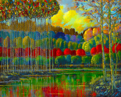 A grove of red and green trees surround the waters edge